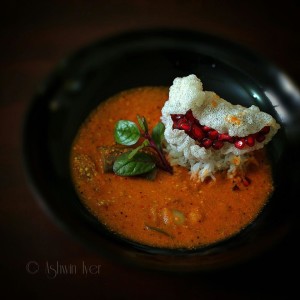 Brinjal, onion and potato sambar with rice, a tapioca crisp and pomegranates